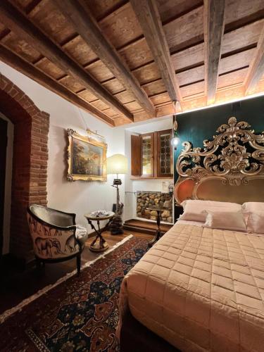 a bedroom with a large bed and a chair at Marcello Sleep&Spa in Verona