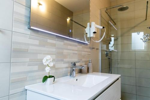a bathroom with a sink and a mirror at Sunny Adriatic in Poreč