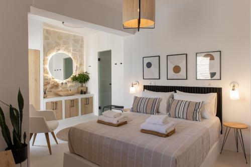 a bedroom with a large bed with two pillows on it at Casa Prasoul Villa with Heated Pool & Fitness area in Prasiaí