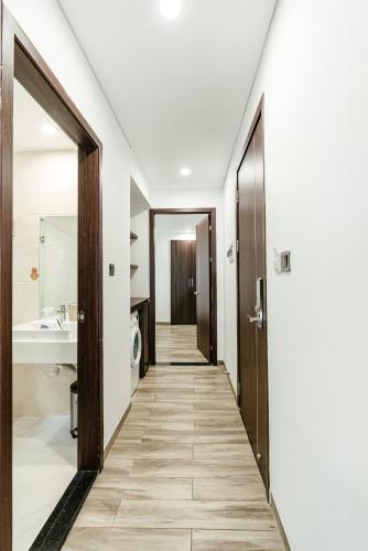 a hallway leading to a bathroom with a sink at SWEDEN HOTEL and APARTMENT in Da Nang