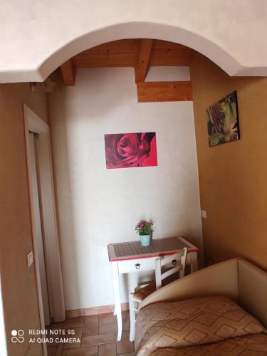 a bedroom with a table and a bed in a room at B&B Al Cristo in SantʼAmbrogio di Valpolicella