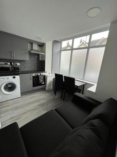 a living room with a couch and a kitchen at Apartment in St Denys in Southampton