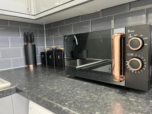a black microwave in a kitchen with a counter top at Apartment in St Denys in Southampton