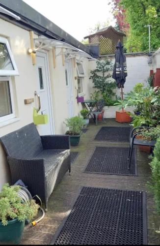 an outdoor patio with black metal grates and plants at The Old Royal George in Northallerton