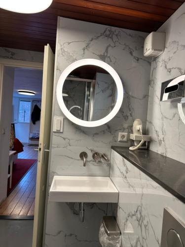 a bathroom with a sink and a mirror at Boat no Breakfast in Amsterdam