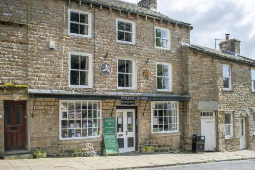 a brick building with a store in front of it at Knights Rest in Redmire