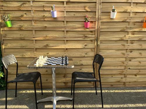 a chess board on a table with two chairs at L Abri-côtier Appartements in Saintes-Maries-de-la-Mer