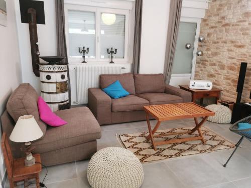 a living room with a couch and a table at Villa Jeanne Marie in Saint-Pair-sur-Mer