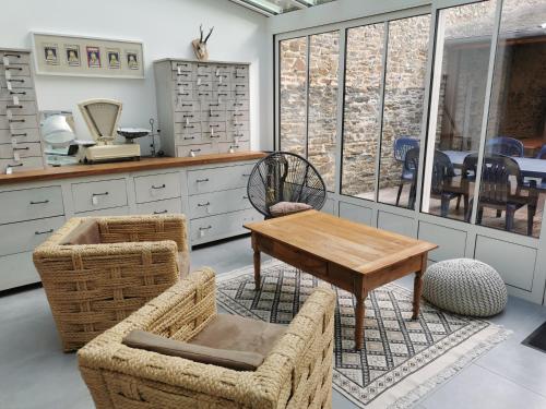 a kitchen with a table and chairs in a room at Villa Jeanne Marie in Saint-Pair-sur-Mer