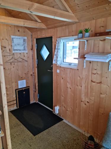 a small room with a door and a window at Hjallurin in Sandavágur