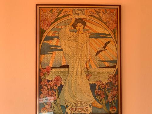 a painting of an angel on a wall at Betty's House in Lazise
