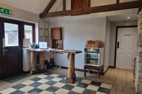 a kitchen with a table and an oven in a room at Kingston Country Courtyard in Kingston