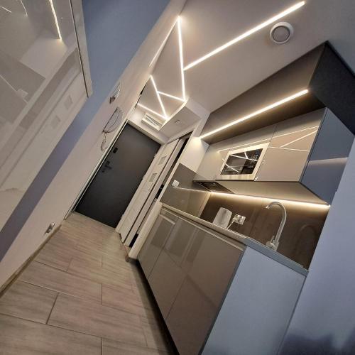 a small kitchen with a staircase leading to a hallway at Apartament Źródełko in Krynica Zdrój