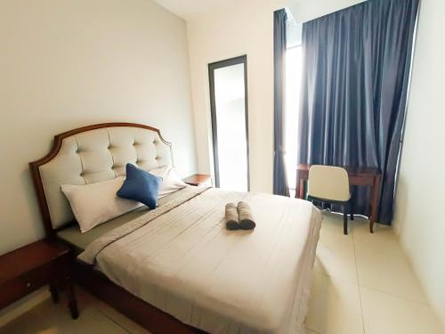 a bedroom with a bed with a pair of shoes on it at Medini Elysia Park , 3 min to Legoland, Netflix By Hint Homestay in Nusajaya