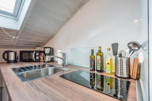 a kitchen with a sink and a counter top at Modernes Apartment zum Wohlfühlen in Kolbermoor