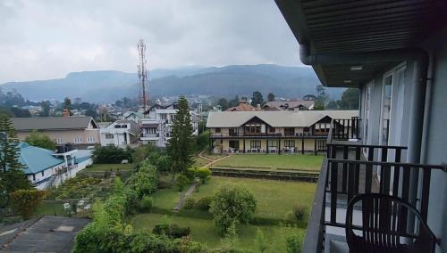 a balcony of a house with a view of a yard at Knightsbridge Grand Apartment in Nuwara Eliya