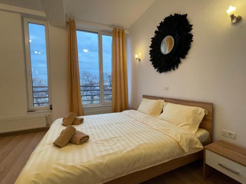 a bedroom with a large bed with a mirror on the wall at NEW Central nr5 Self Checkin OldCity Center Paid Parking with Lift in Timişoara