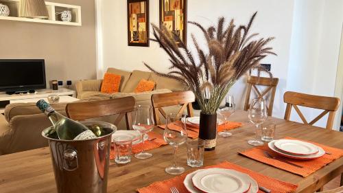 ラ・イスレタ・デル・モロにあるApartamento de 3 dormitorios a 60 m de la playa en la Isleta, Cabo de Gataのダイニングルームテーブル(ワイン1本、グラス付)