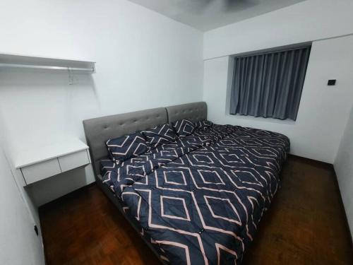 a bedroom with a bed in a room at XHQ Home Stay - BayView B-9-1 in Kampong Baharu