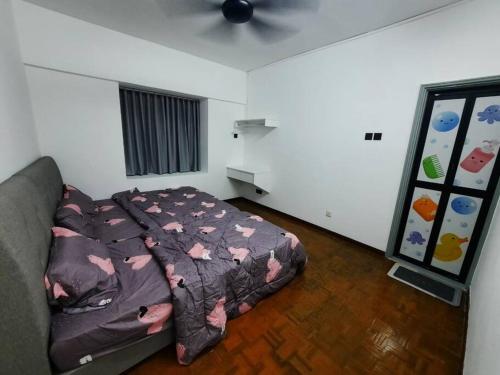 a bedroom with a bed and a ceiling fan at XHQ Home Stay - BayView B-9-1 in Kampong Baharu