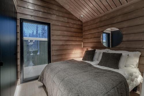 a bedroom with a bed in a room with a window at Villa Laponia in Äkäslompolo