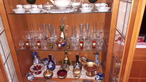 a shelf filled with glass vases and other items at L'aura Veneziana in Venice