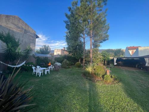 un jardín con mesa y sillas en el patio en Casa Villa de Merlo en Merlo