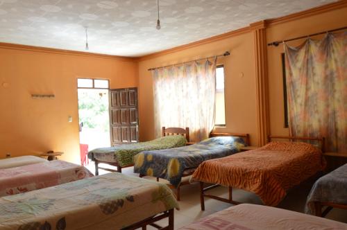 En eller flere senge i et værelse på Hostal Coronel Pedro Arraya