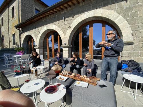 a man eating food in front of a group of people at Villa Paladini in Montefiascone