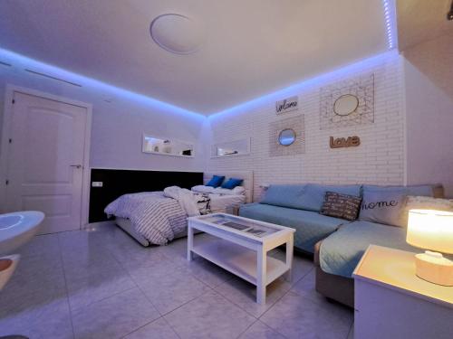 a living room with a couch and a bed at Mirador in Alicante