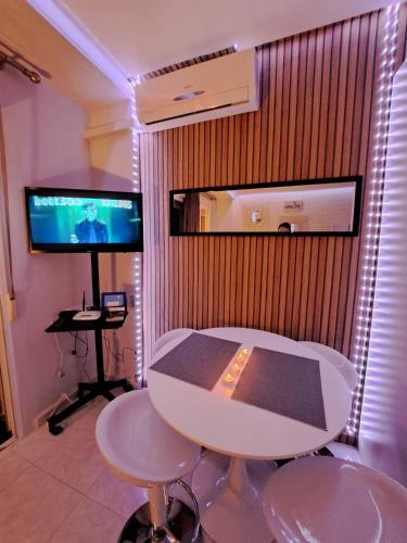 a room with a table and chairs and a television at Mirador in Alicante