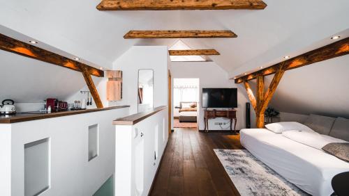 a bedroom with white walls and wooden beams at Hotel Guesthouse Dalnig in Bad Kleinkirchheim