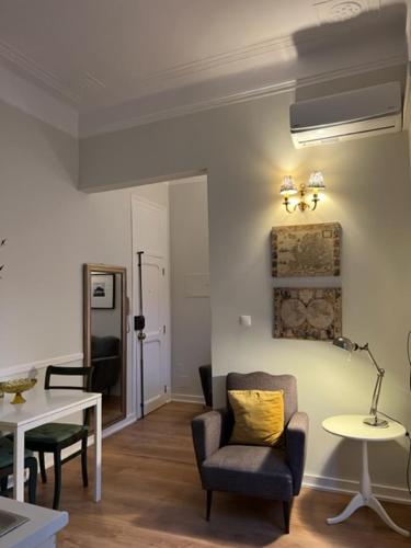 a living room with a chair and a table at Romantic & Renewed 1 bedroom Apartment in Campolide - 67 1E in Lisbon