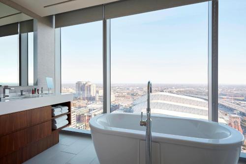 a bath tub in a bathroom with a large window at Marriott Marquis Houston in Houston