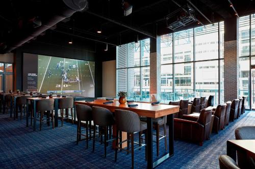 a conference room with tables and chairs and a screen at Marriott Marquis Houston in Houston