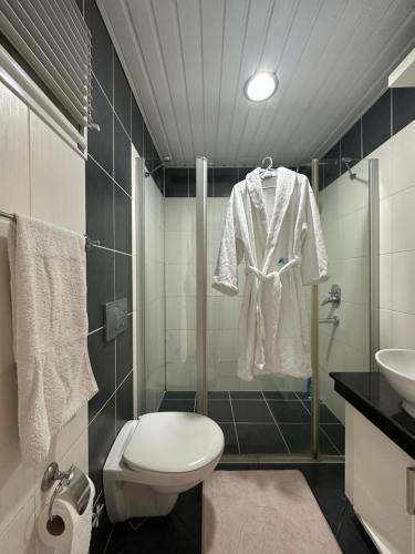 a bathroom with a shower and a toilet and a sink at Odyssey Park in Belek