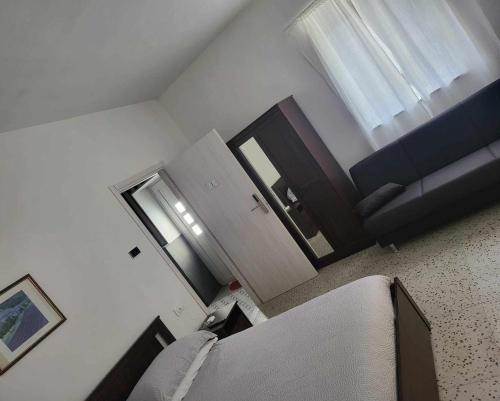 a living room with a couch and a window at La Bolgora Guesthouse in Novara