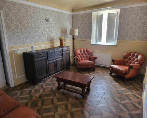 a living room with chairs and a tv and a table at La Bolgora Guesthouse in Novara