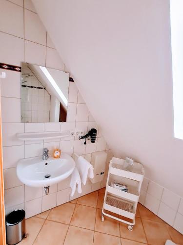a bathroom with a sink and a mirror at Ambiente Ferienwohnungen in Sankt Martin