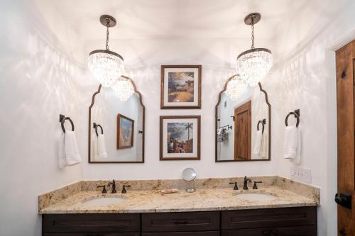a bathroom with two sinks and three mirrors at Casa Pap Del Mar in Key West