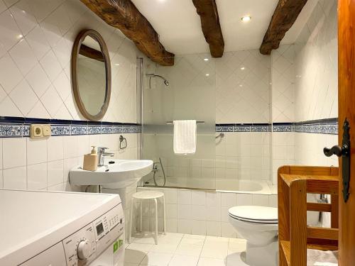 a bathroom with a sink and a toilet and a tub at Casa Rural Erreteneko borda in Vera de Bidasoa