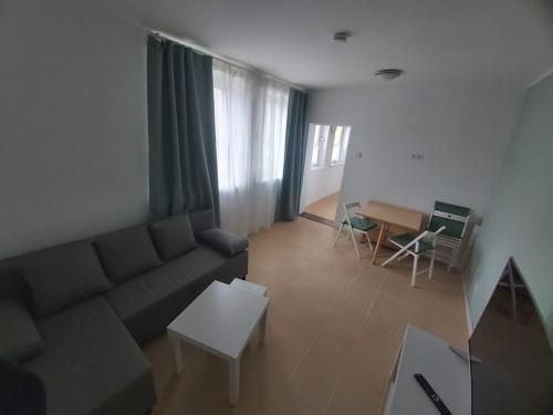 a living room with a couch and a table at Am Bahnhof Ketzin in Ketzin