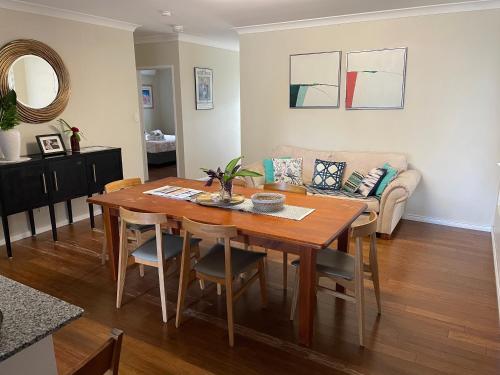 a living room with a table and a couch at Cheerful city house in Cairns