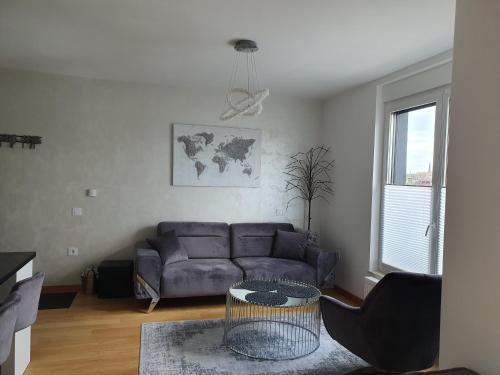 a living room with a couch and a table at Centar view lux in Novi Sad