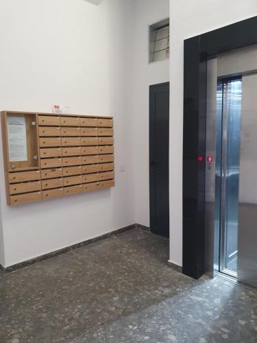 a room with a wooden cabinet on the wall at Centar view lux in Novi Sad