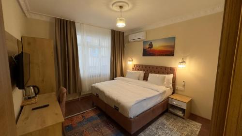 a hotel room with a bed and a television at Albatros Apart Suite in Istanbul