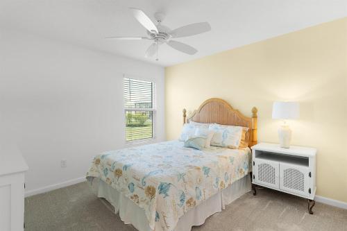 a bedroom with a bed and a ceiling fan at Relaxing, Golf, Pools, Hiking, events in Wildwood