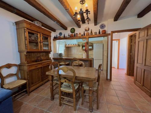 a kitchen with a wooden table and a dining room at CASA RURAL VELEFIQuE in Velefique