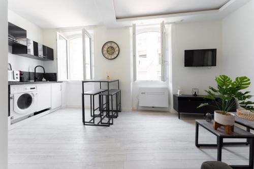 een witte woonkamer met een keuken met een wasmachine en droger bij Au cœur du Panier, Confort à 2 pas du Port ! in Marseille