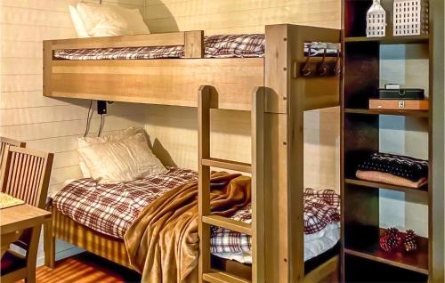 a bunk bed in a room with a bed in a room at Stunning Apartment In Slen With Kitchen in Sälen